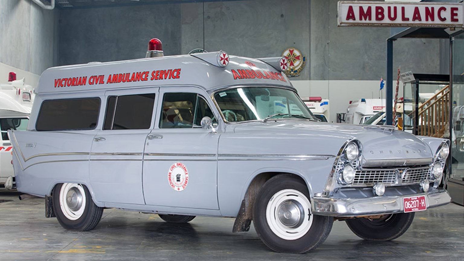 A classic vintage ambulance resting in a garage, highlighting its unique features and nostalgic charm.