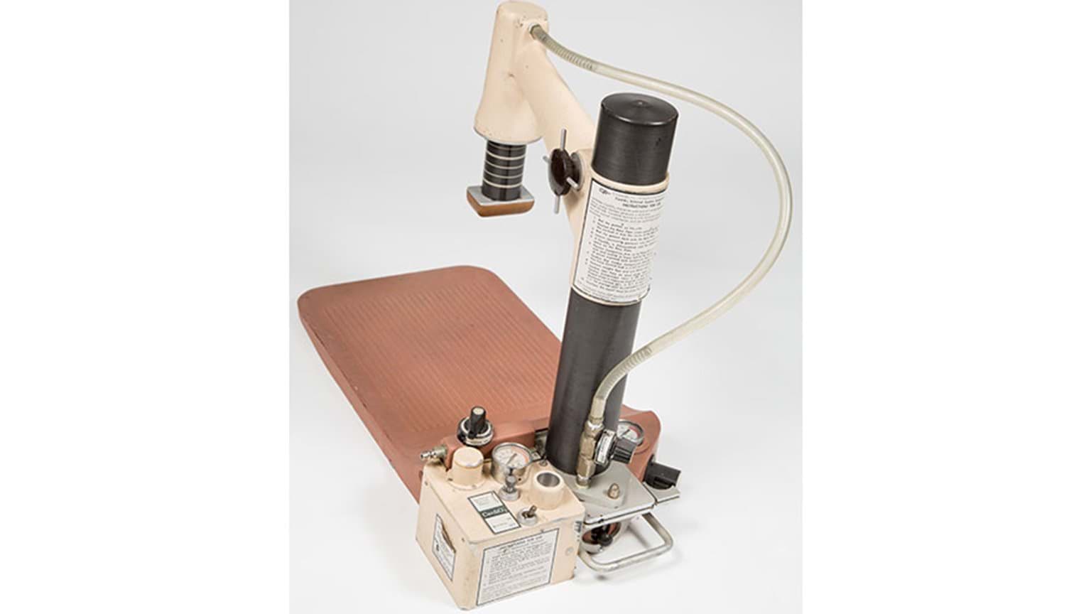 An old medical equipment featuring a hose connected to it.