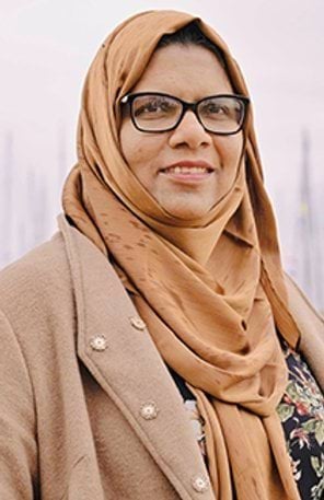 A woman wearing glasses and a headscarf