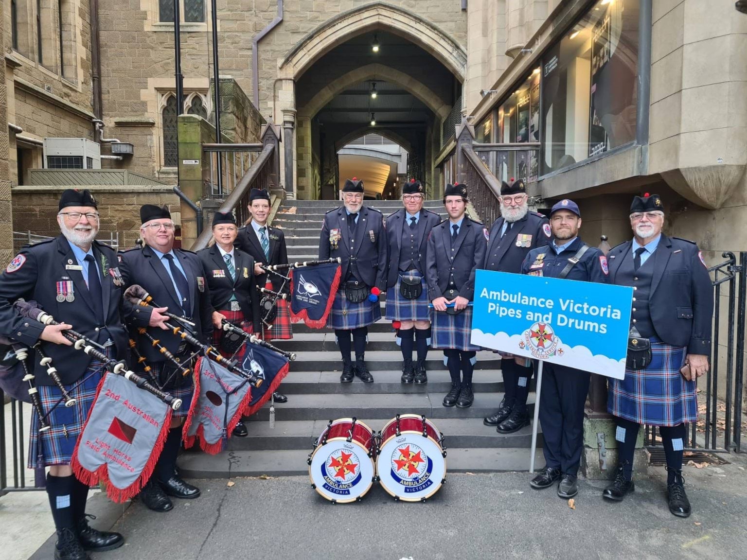 Members of AV Pipes and Drums pose outside at Anzac Day