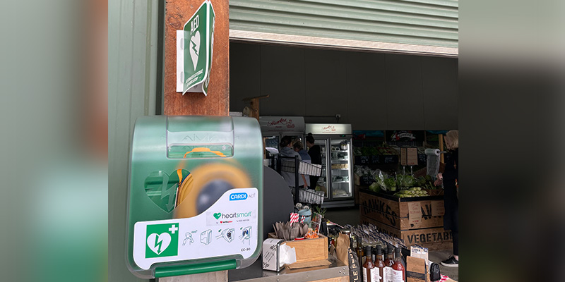 An automated external defibrillator device has been installed outside the entrance of a grocery store.