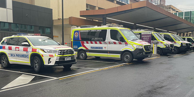 A row of ambulances parked at a hospital.