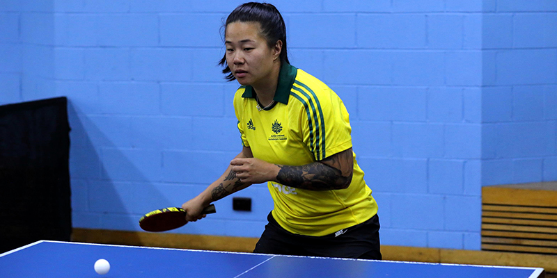 A female athlete playing table tennis.