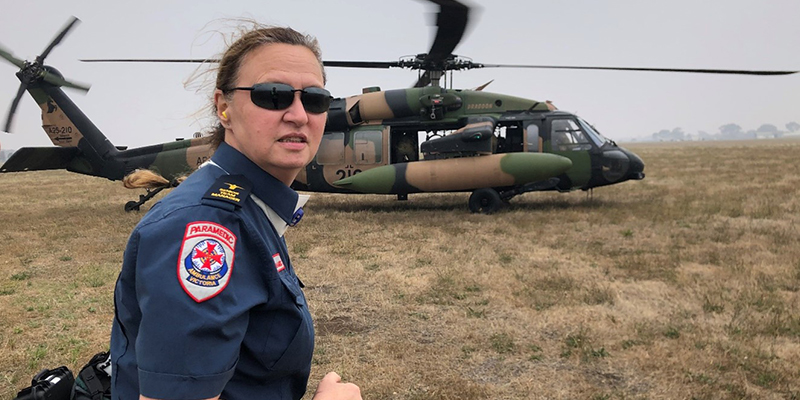 A female paramedic ready to board an army helicopter.
