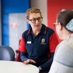 Ambulance Victoria Peer Support person speaking with a staff member.