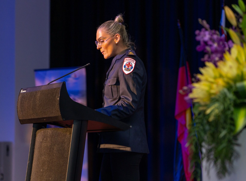 A woman giving a speech at a podium.