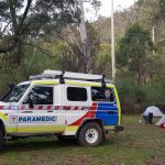 Ambulance Victoria car parked next to a campsite.