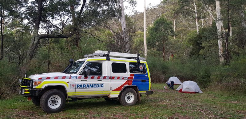 Ambulance Victoria car parked next to a campsite.