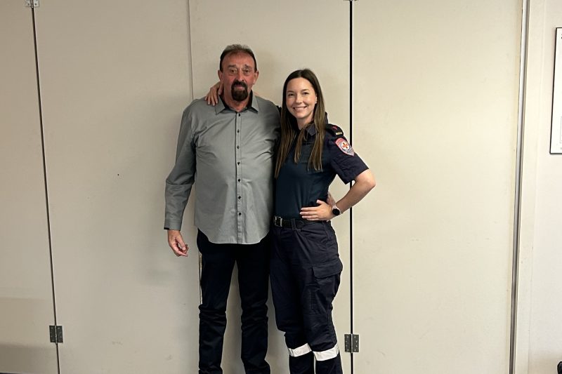 A man standing next to a smiling female paramedic