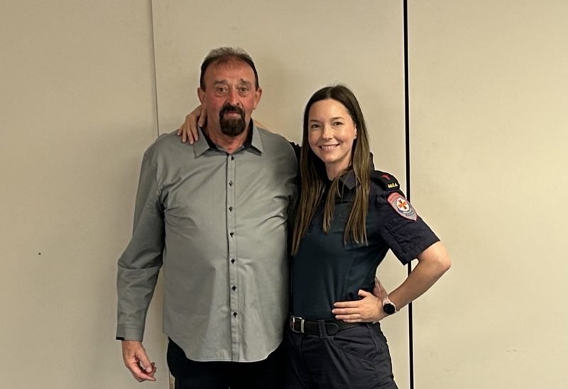 A man standing next to a smiling female paramedic