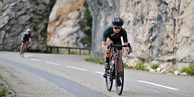 Two cyclist racing along a road.