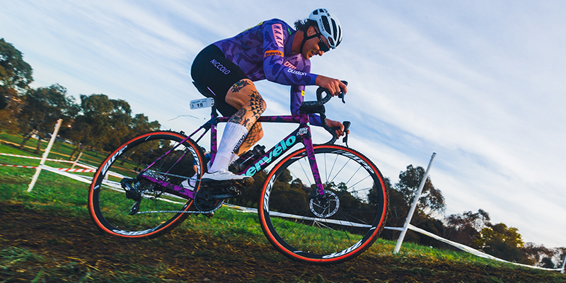 A man is racing with his bicycle on a dirt track.