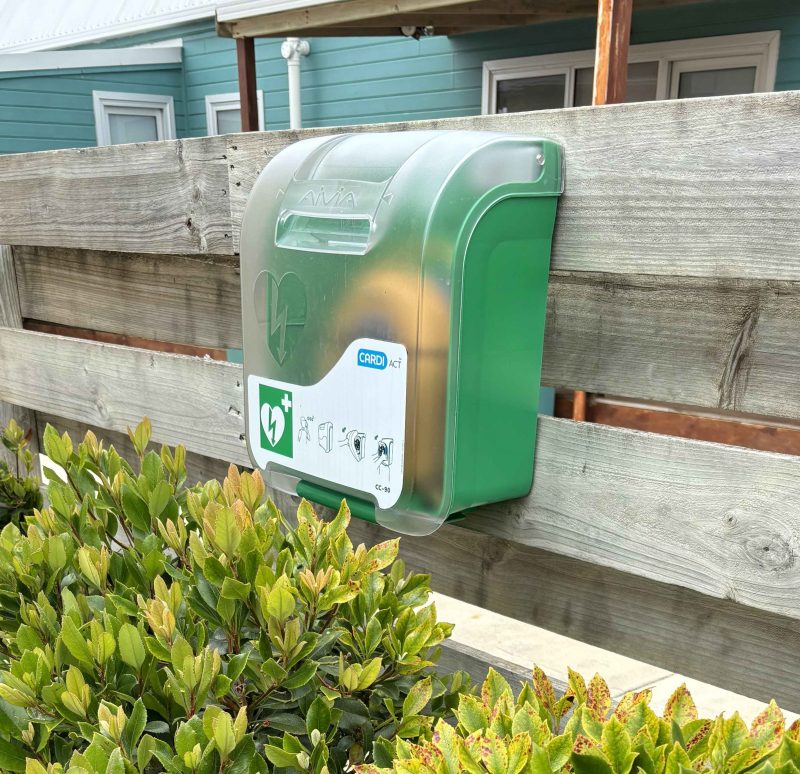 A defibrillator attached to a fence.