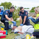 Paramedics providing CPR to a person in cardiac arrest.