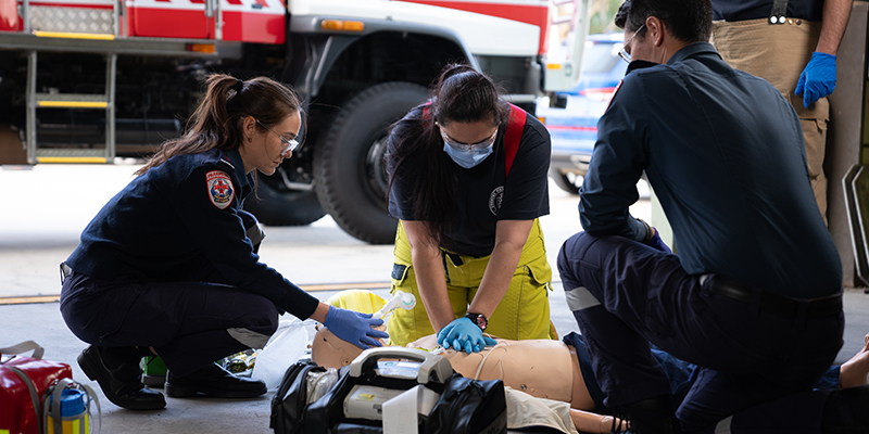 Several people in a garage showcasing teamwork and emergency preparedness.