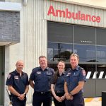 A group of paramedics outside an ambulance branch.