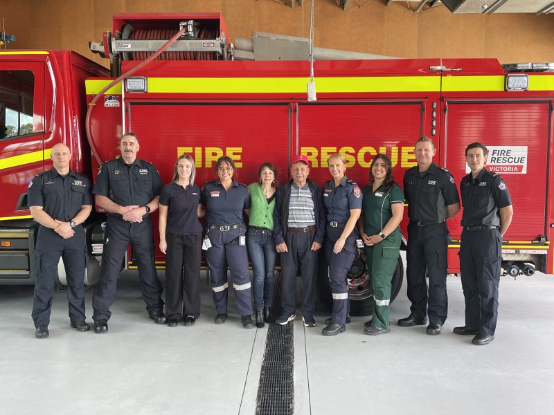 A large group of people standing in front of a fire truck.