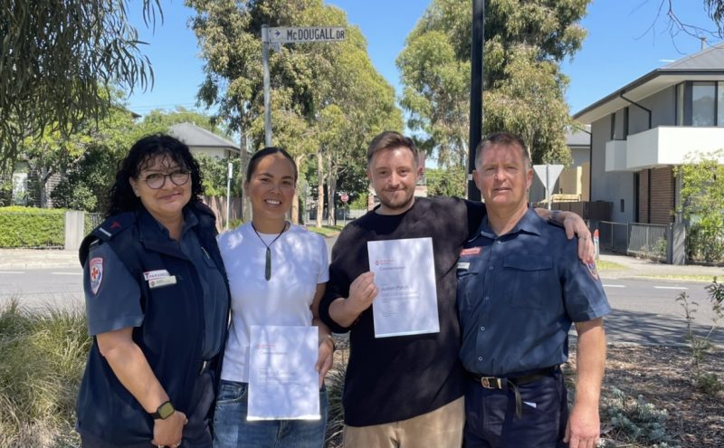 Four people smiling.