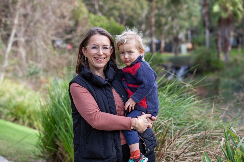 A woman holding a young boy.