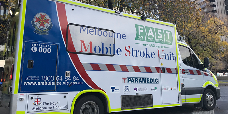 A specially designed ambulance for treating stroke patients parked along a city streets.