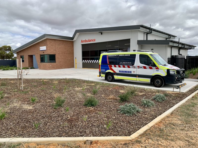 A building with an ambulance parked out the front.