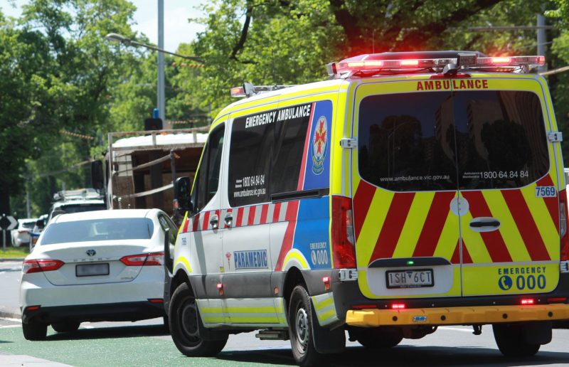 ambulance trying to make its way through traffic