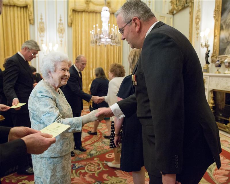 Paul shaking hands with Queen Elizabeth